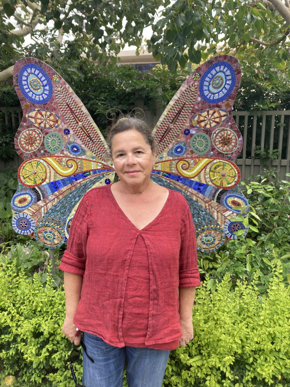 Mosaicist Irina Charny poses in front of one of her mosaics displayed at the Sherman Library & Gardens.