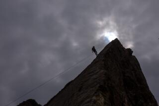 Malibu, CA - September 12: Climber Kevin Fentress, of Brooklyn. NY, belays down the high seaside cliff at Point Dome under overcast skies on Thursday, Sept. 12, 2024 in Malibu, CA. Weather in Southern California will continue to cool over the weekend with highs in the 70s along the coast to 90 degrees inland. (Brian van der Brug / Los Angeles Times)