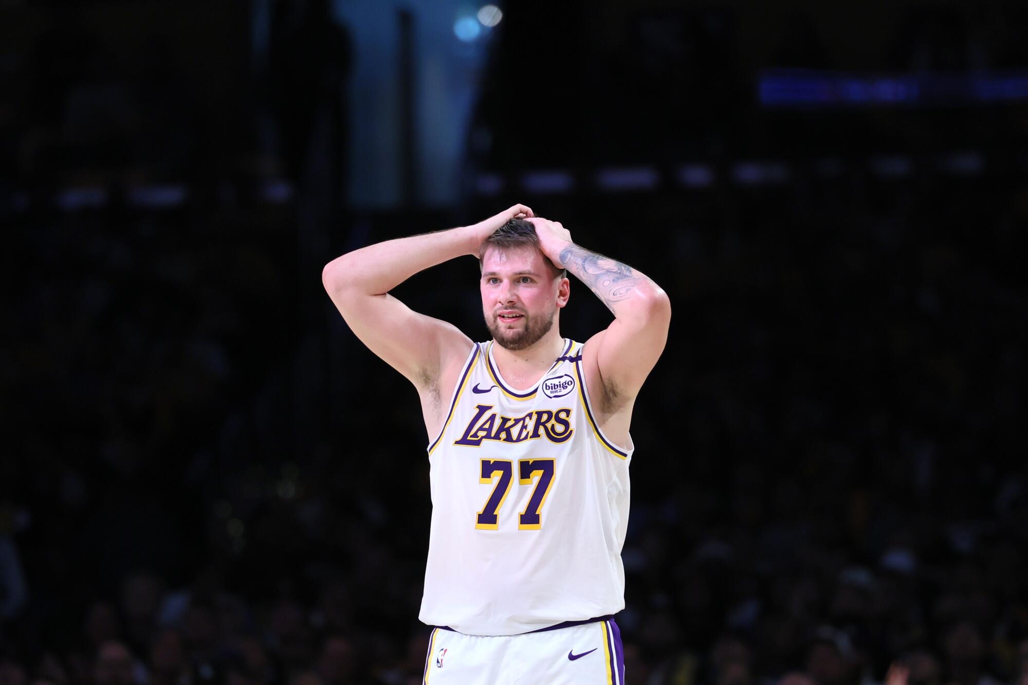Lakers guard Luka Doncic reacts by holding his hands to his head during a Game 1 playoff loss to the Timberwolves