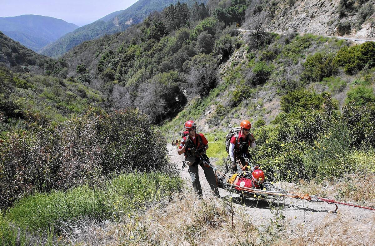 In this file photo, a rescue team brings up a "victim" during a training exercise on Angeles Crest Highway in the Angeles National Forest.