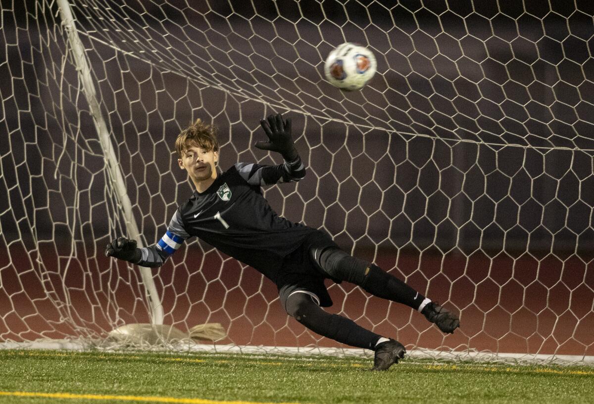 Costa Mesa's Ethan Smithlin attempts to block a penalty shot in the second Battle for the Bell in boys' soccer on Wednesday.
