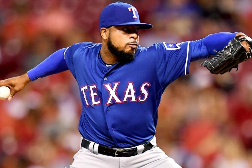 Rangers reliever Jeremy Jeffress delivers a pitch against the Reds during a game Aug. 23.
