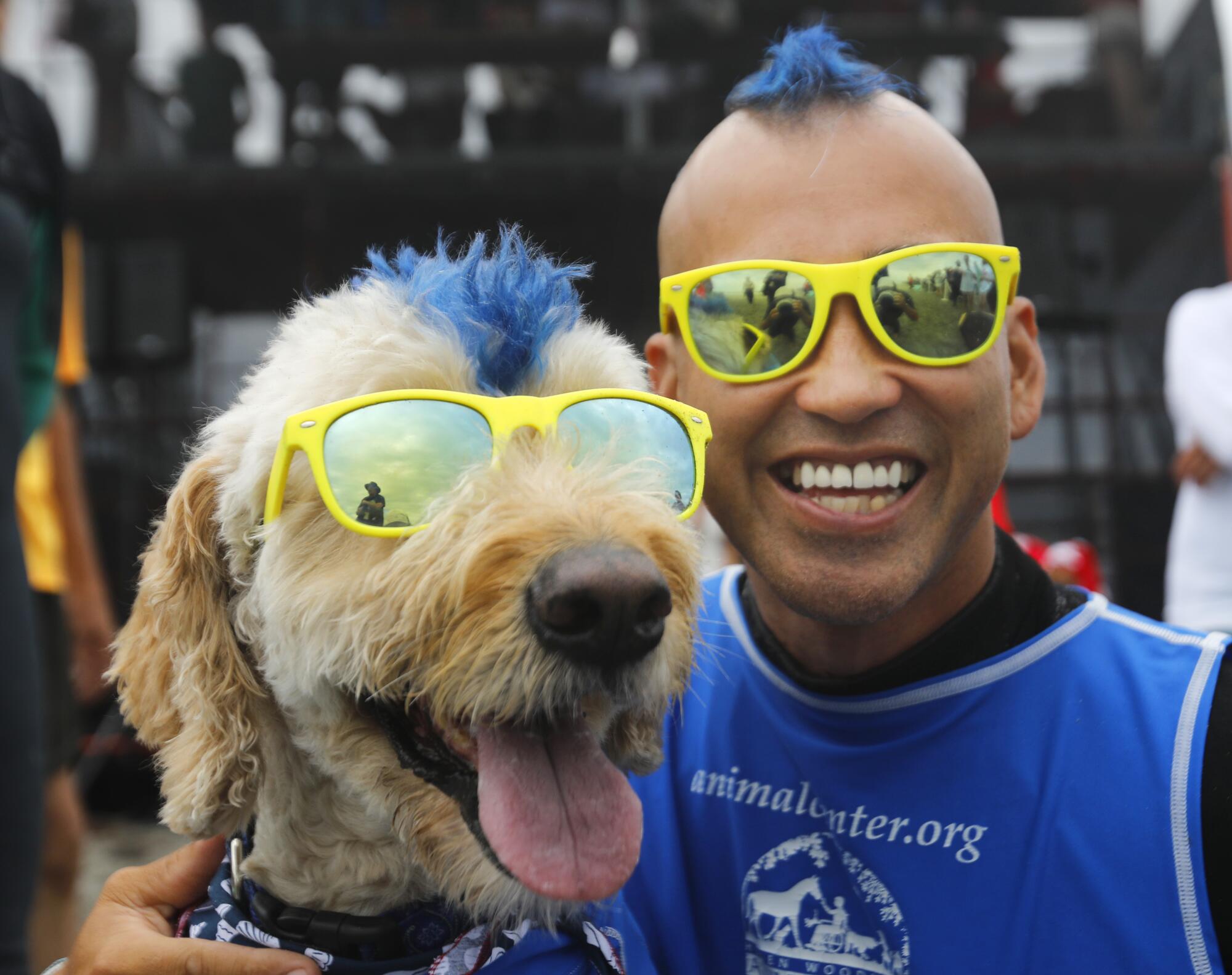 Kentucky Gallahue and his dog Derby sport matching mohawks and glasses before surfing.