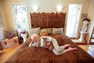 Nancy Gerrish, 78, sits on her cherished waterbed with her dog Penny.