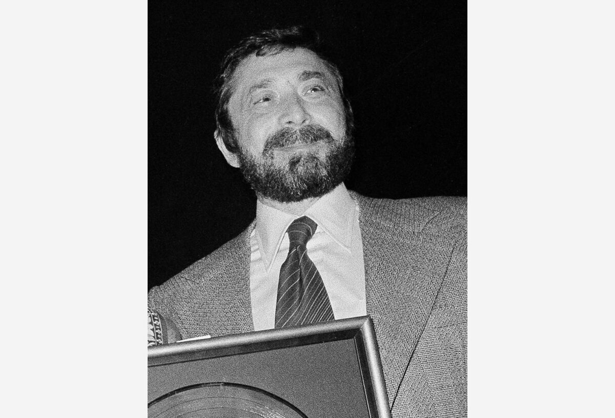 FILE - Walter Yetnikoff, president of CBS Records, presents gold records in New York on Jan. 17, 1978. Yetnikoff, the rampaging, R-rated head of CBS Records who presided over blockbuster releases by Michael Jackson, Billy Joel and many others and otherwise devoted his life to a self-catered feast of “schmoozing, shmingling and bingling,” has died at age 87. Yetnikoff's death was confirmed Tuesday, Aug. 10, 2021, by David Ritz, who collaborated with Yetnikoff on his memoir “Howling at the Moon.” (AP Photo/Carlos Rene Perez, File)