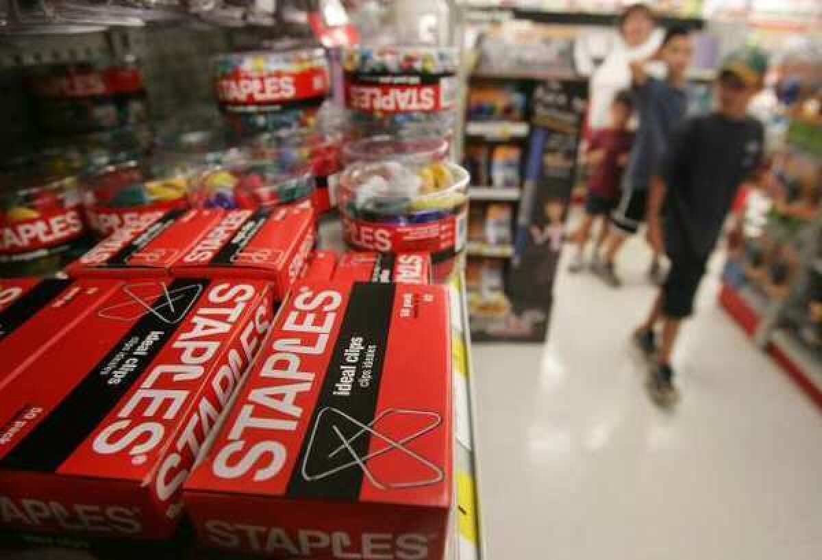 Staples stock jumped after a report that private equity firms, including Bain, were considering a buyout of the company.