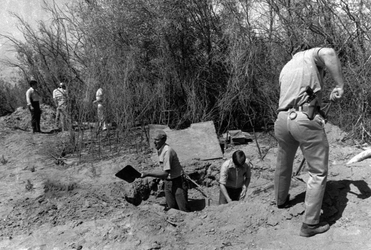Men with shovels dig at a rock quarry