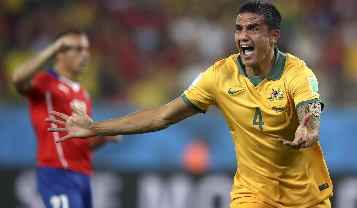 Australia's Tim Cahill celebrates after scoring on a header against Chile.