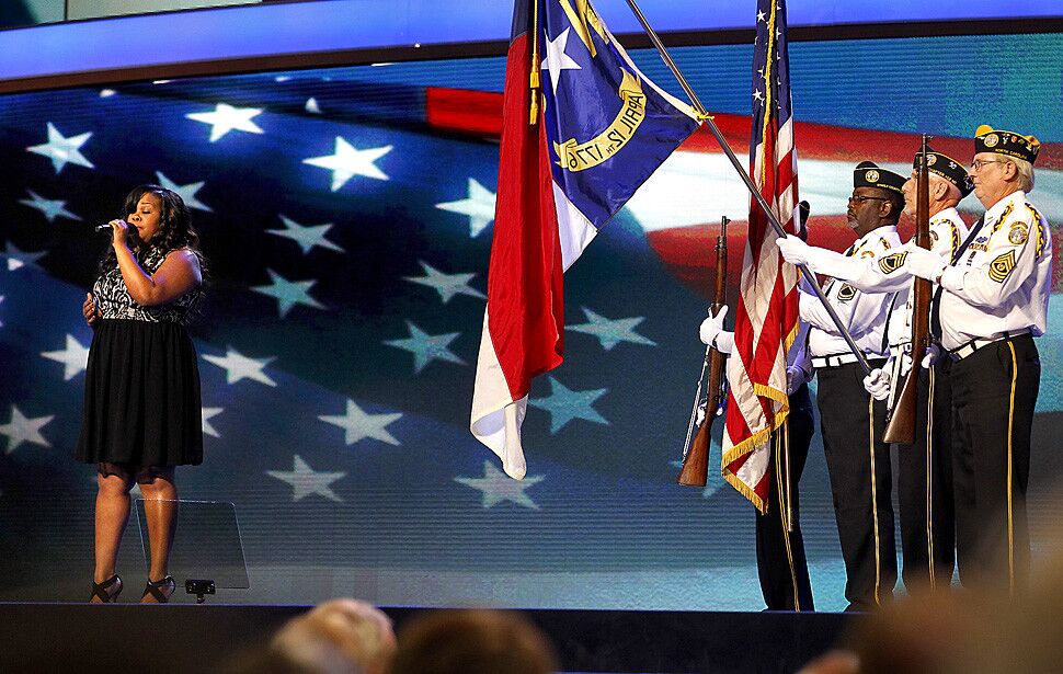 "Glee" actress Amber Riley, left, sings the national anthem at the start of the Democratic National Convention in Charlotte, N.C. The Disabled American Veterans Honor Guard, right, presents the colors.
