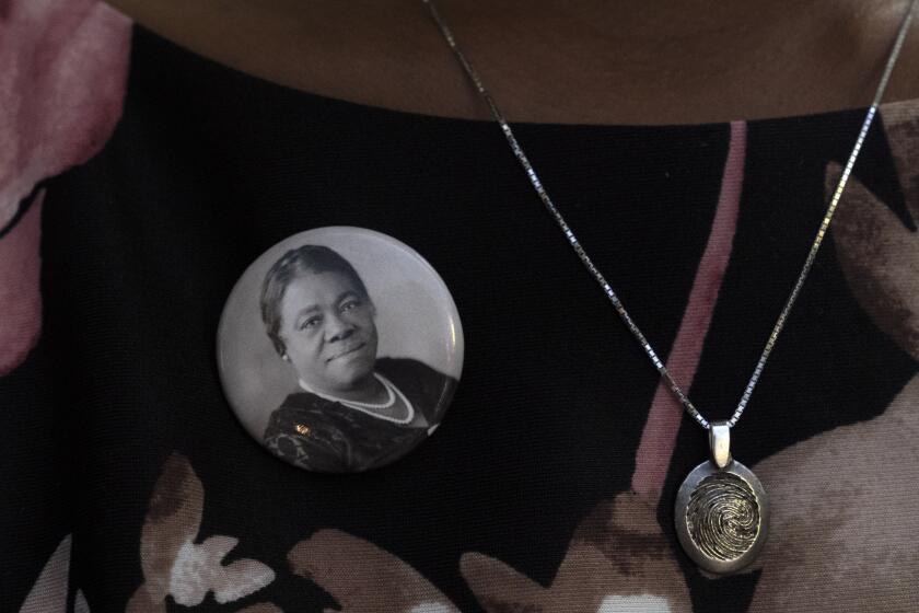 A woman wears a pin of Mary McLeod Bethune, during a statue unveiling ceremony in honor of Bethune in Statuary Hall, Wednesday, July 13, 2022, at the U.S. Capitol in Washington. Bethune, the founder of Bethune-Cookman University, was one of America’s most important educators, civil and women’s rights leaders and government officials of the 20th century. (AP Photo/Jacquelyn Martin)