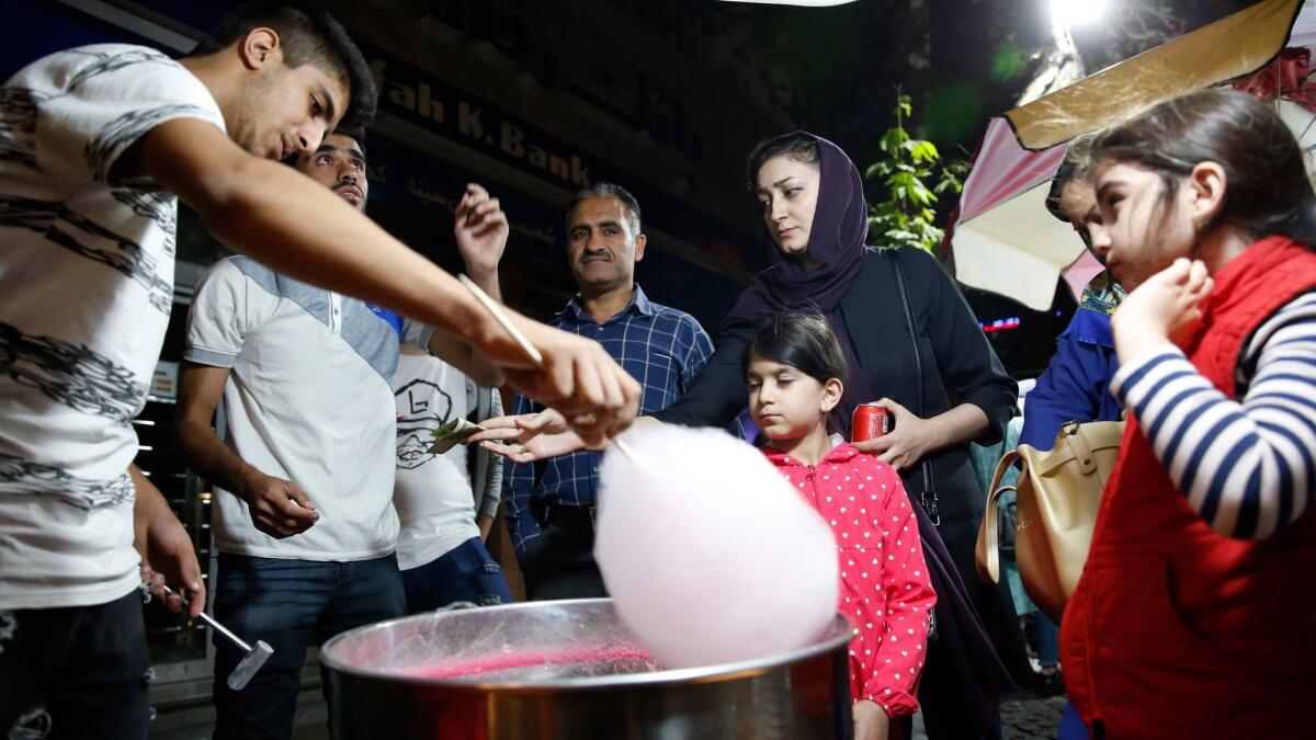 People queue to buy cotton candy at a street food market in Tehran, Iran on Oct. 11.