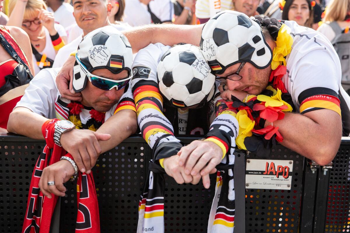 Fans react as they watch Germany's loss to South Korea at the public viewing area in front of the Brandenburg Gate in Berlin.