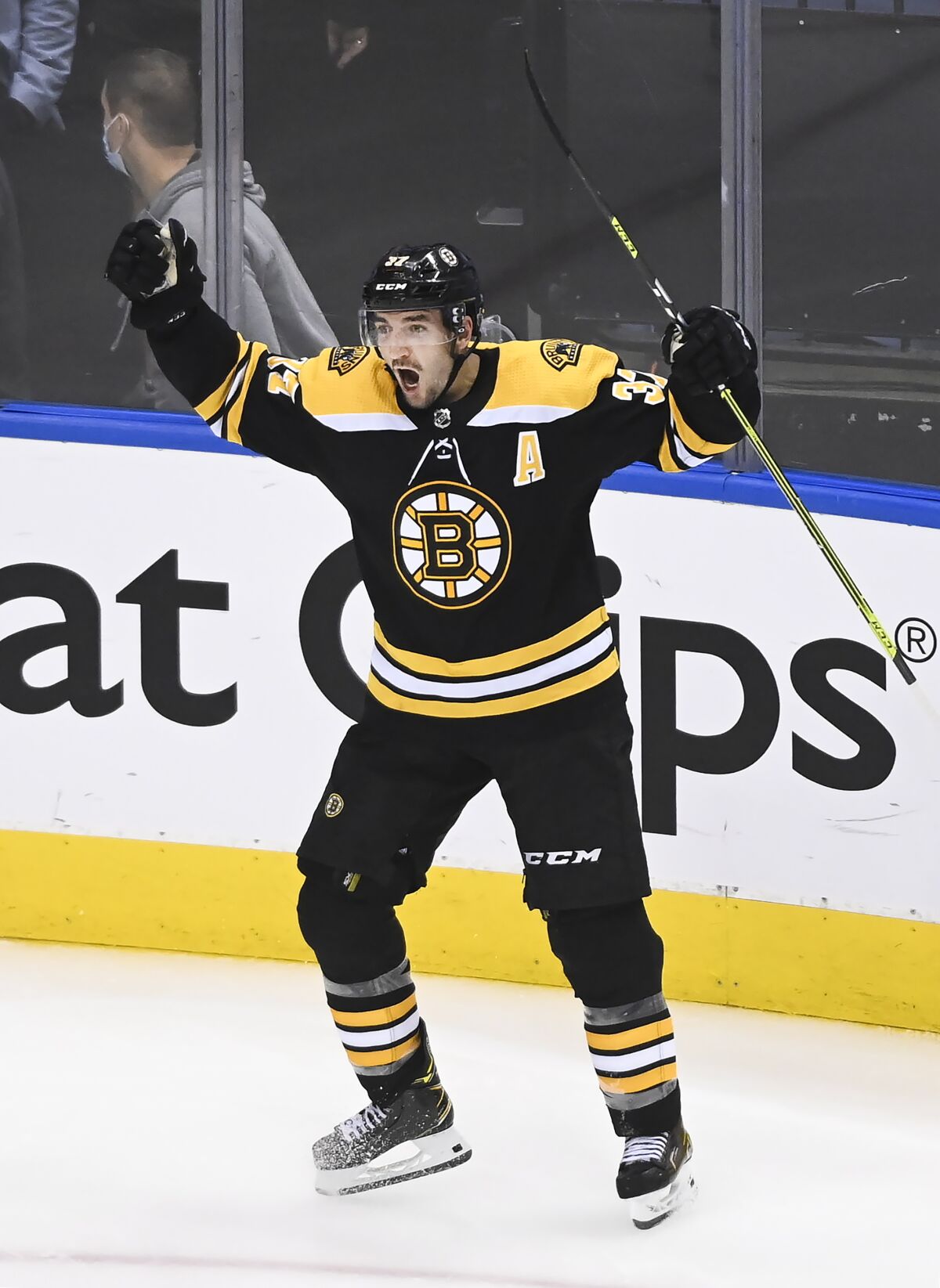 Boston Bruins center Patrice Bergeron (37) reacts after scoring the game winning goal against the Carolina Hurricanes during the second overtime period of an NHL hockey Eastern Conference Stanley Cup playoff game in Toronto, Wednesday, Aug. 12, 2020. (Nathan Denette/The Canadian Press via AP)