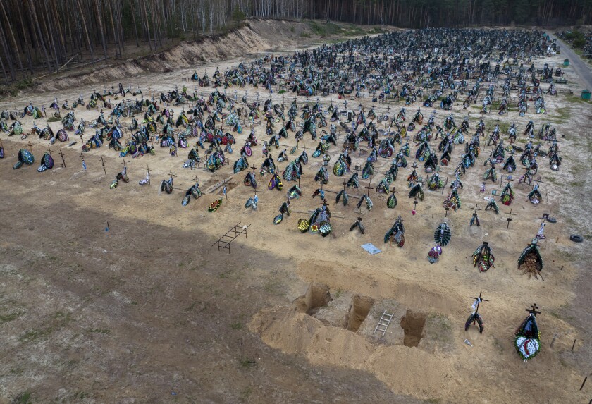 Cemetery with three freshly dug graves