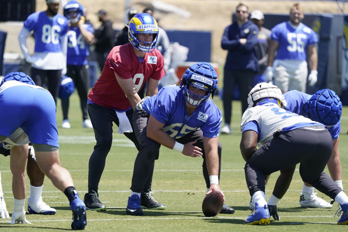  Rams quarterback Matthew Stafford takes a snap from center Coleman Shelton during camp.