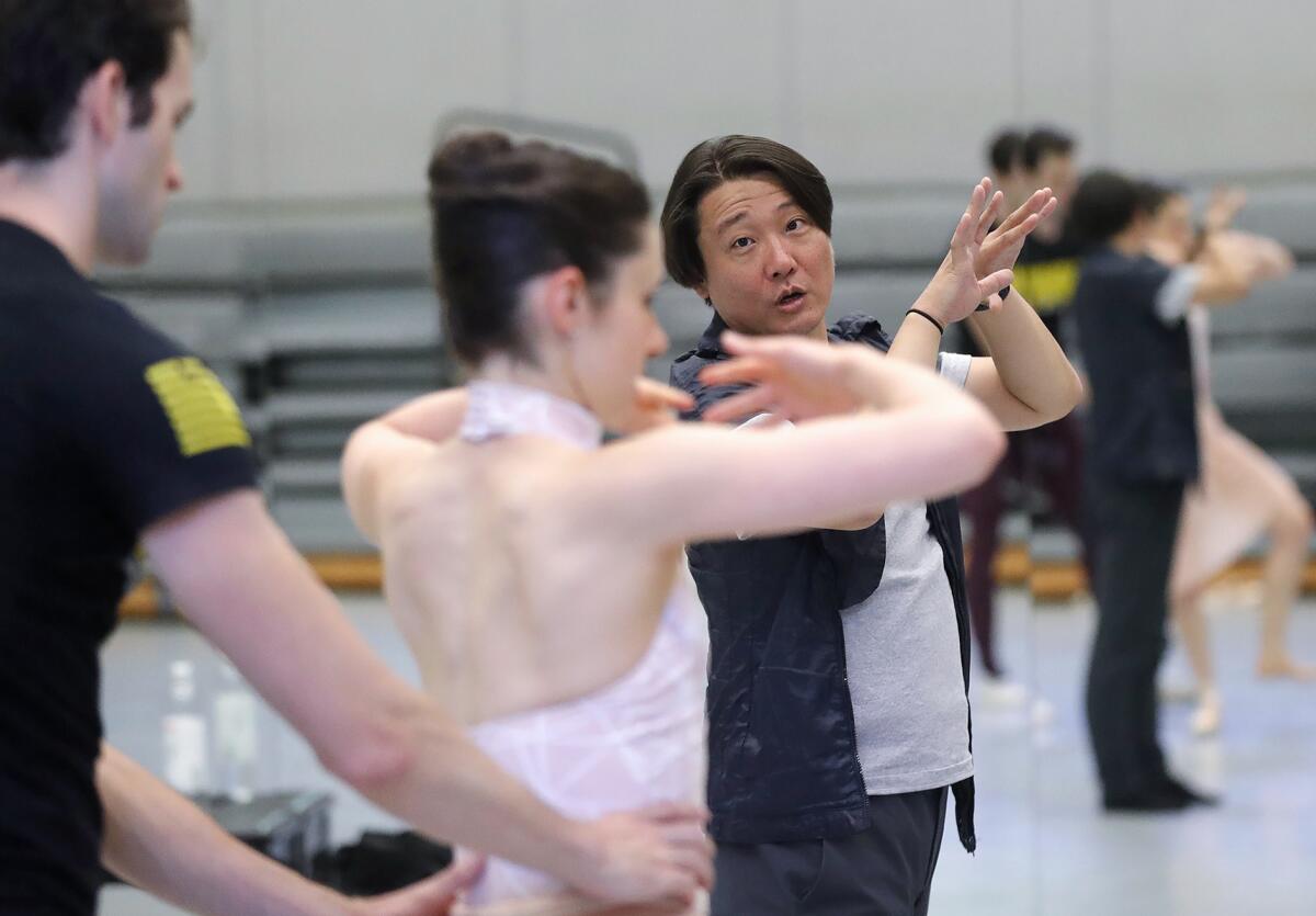 Choreographer Ye Li, right, with dancers Sean Sessions and Anwen Brown work on a piece.