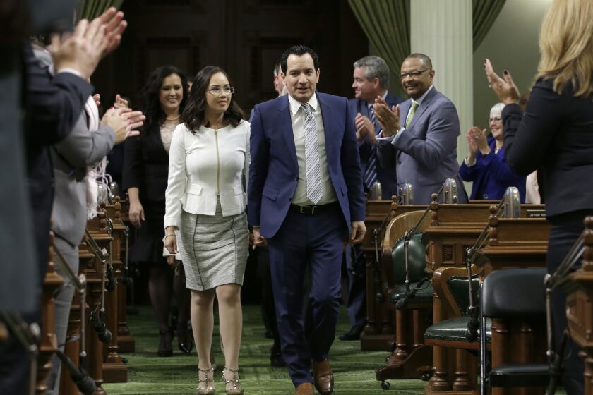 Assemblyman Anthony Rendon, D-Paramount, and his wife, Annie Lam, walk down the center isle of the Assembly during ceremonies where is was sworn-in as the 70th Speaker of the California Assembly, Monday, March 7, 2016, in Sacramento, Calif. Rendon replaces Toni Atkins, D-San Diego, who be leaving office due to term limits at the end of this year's legislative session.(AP Photo/Rich Pedroncelli)