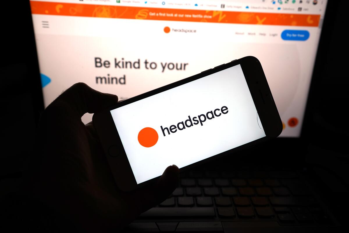 The word Headspace is seen on a mobile phone.