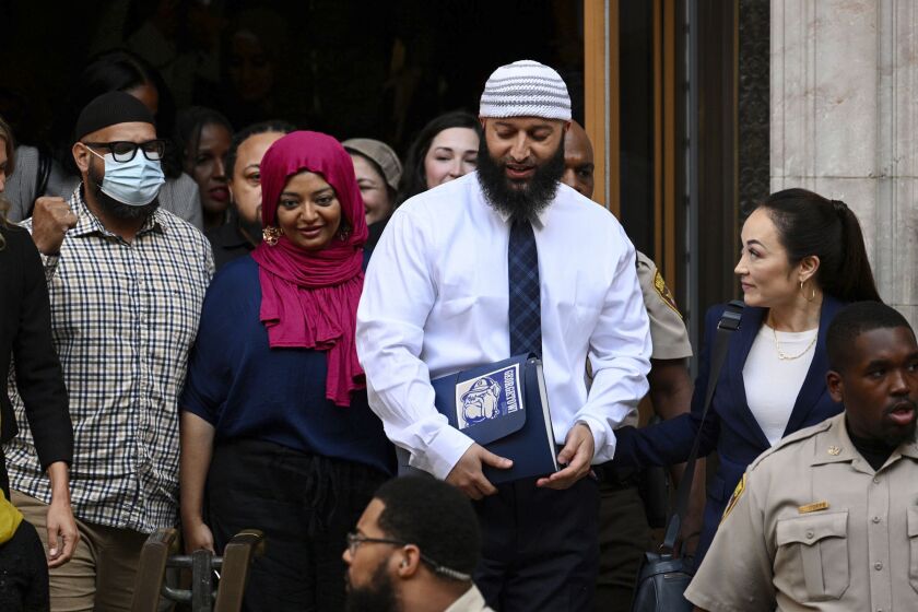 FILE - Adnan Syed, center right, leaves the courthouse after a hearing on Sept. 19, 2022, in Baltimore. A Maryland court did not give the family of the murder victim in the case chronicled in the hit podcast “Serial” enough time to attend a court hearing in person that led to Syed's release, a Maryland appellate court ruled Tuesday, March 28, and it ordered a new hearing to be held. (Jerry Jackson/The Baltimore Sun via AP, File)