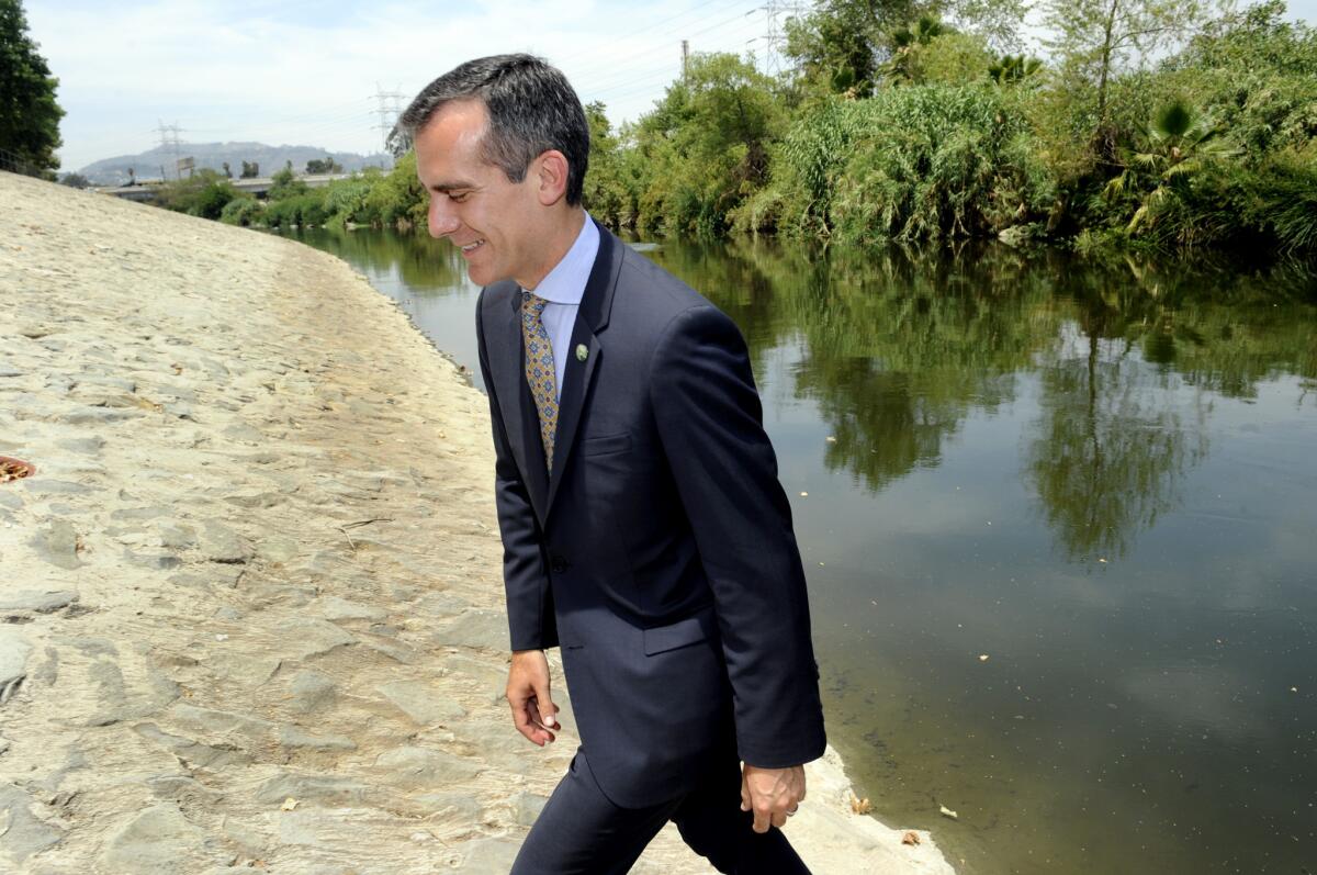 Los Angeles Mayor Eric Garcetti walks to the L.A. River after a press conference in 2014.