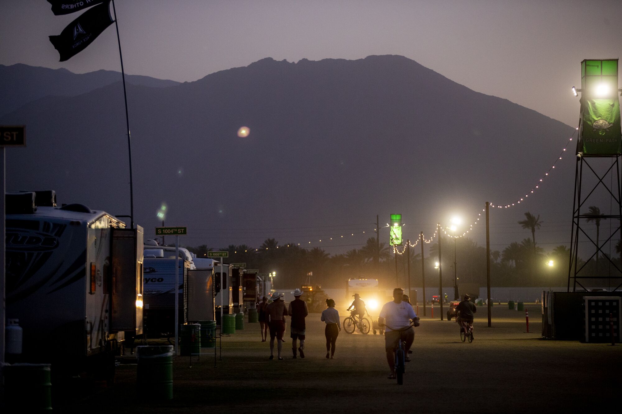 People walk around a campground.
