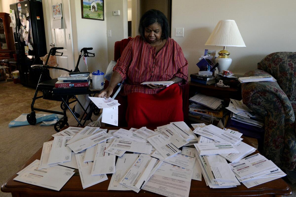 A woman sorting through a pile of bills
