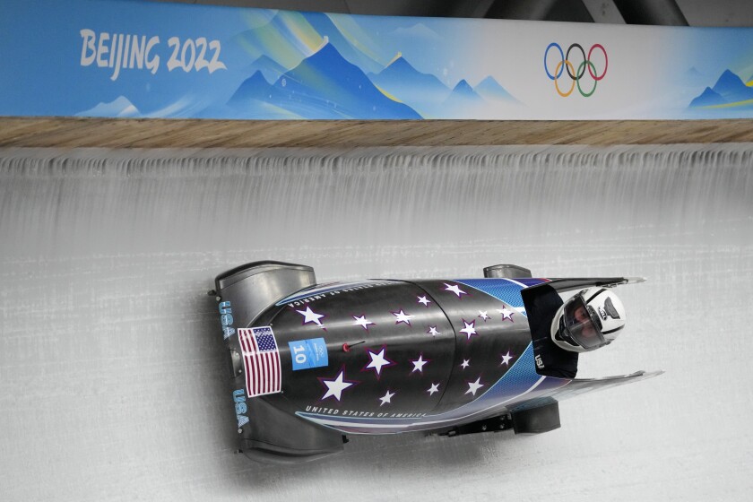 A bobsled speeds across the ice.
