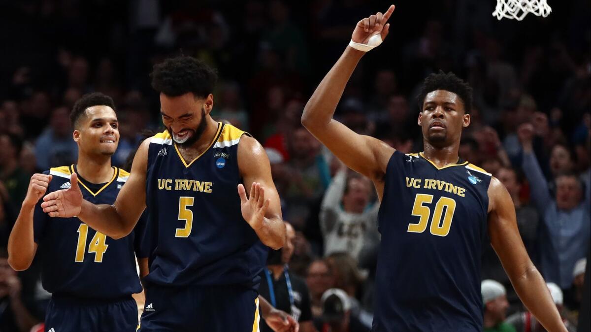 UC Irvine's Evan Leonard, left, Jonathan Galloway, center, and Elston Jones celebrate the Anteaters' victory over Kansas State in the first round of the NCAA tournament on Friday.