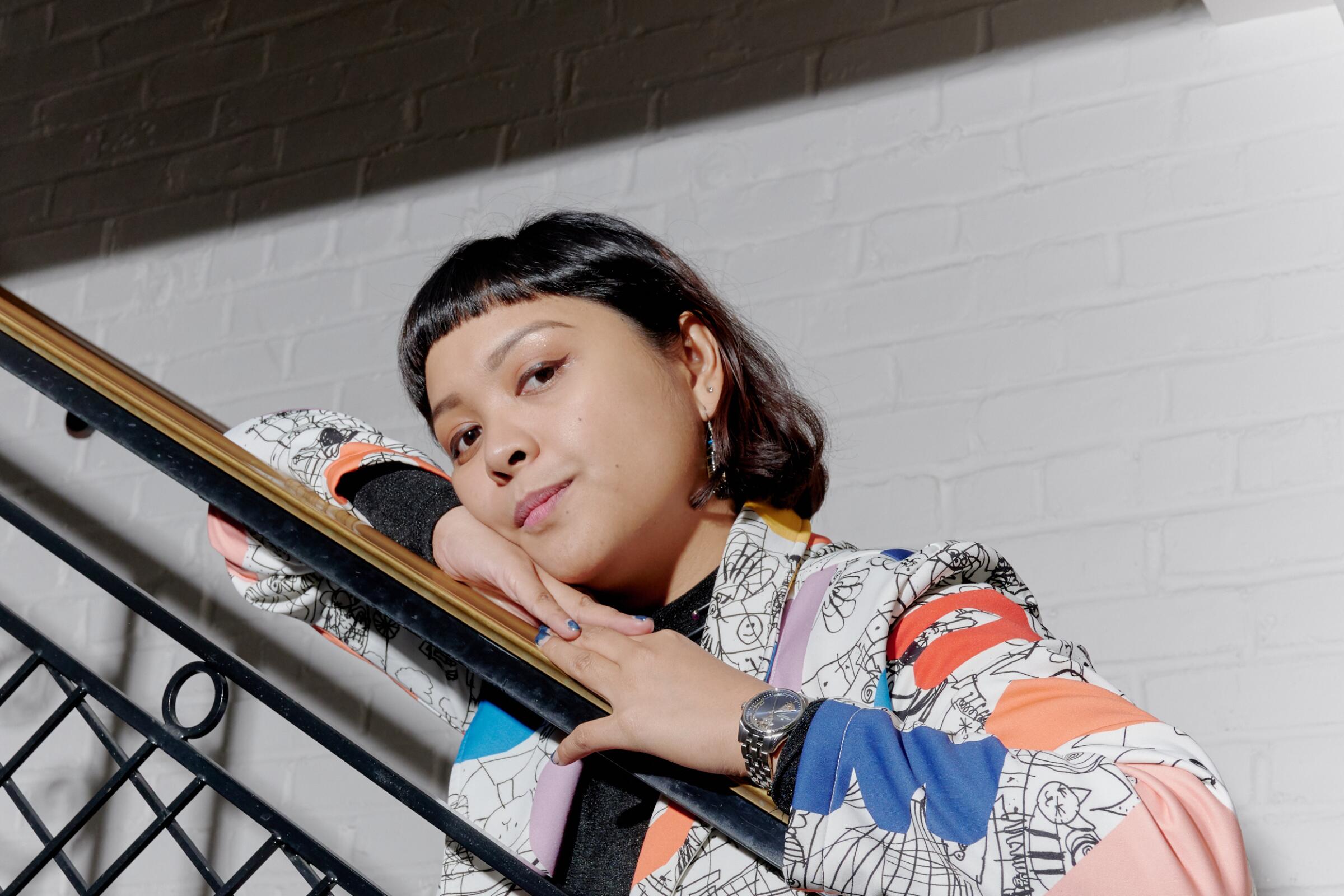 Martika Ramirez Escobar leans on a balustrade.