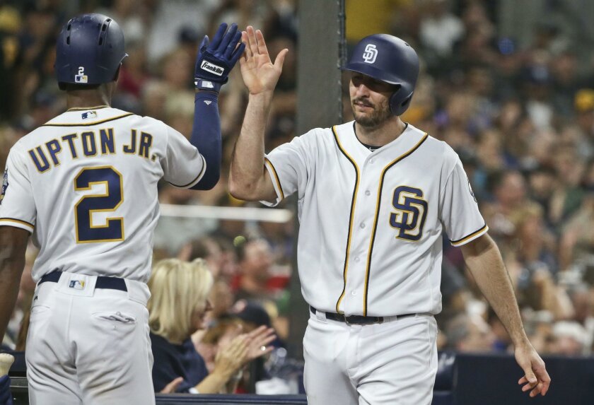 San Diego Padres' Adam Rosales is congratulated by Melvin Upton Jr. after scoring in the Padres' four-run second inning against the Pittsburgh Pirates in a baseball game Wednesday, April 20, 2016, in San Diego. (AP Photo/Lenny Ignelzi)