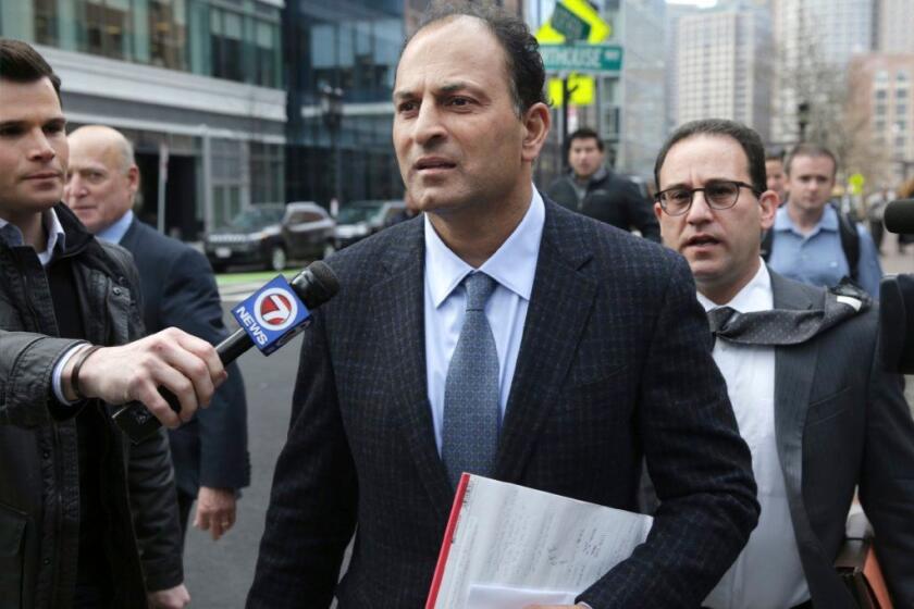 David Sidoo, of Vancouver, Canada, leaves following his federal court hearing Friday, March 15, 2019, in Boston. Sidoo pleaded not guilty to charges as part of a wide-ranging college admissions bribery scandal. (Jonathan Wiggs/The Boston Globe via AP)