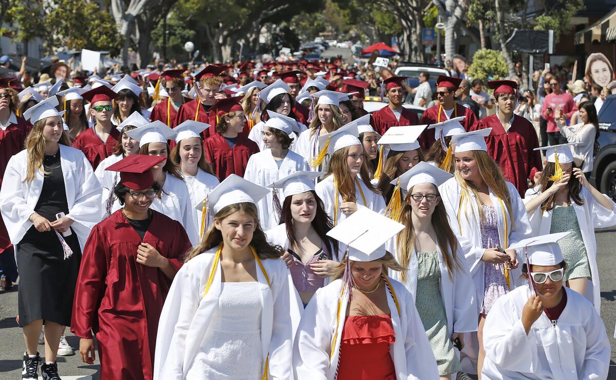 Laguna Beach High seniors fill Ocean Avenue as they walk in the 2023 graduate parade to Main Beach on Wednesday.