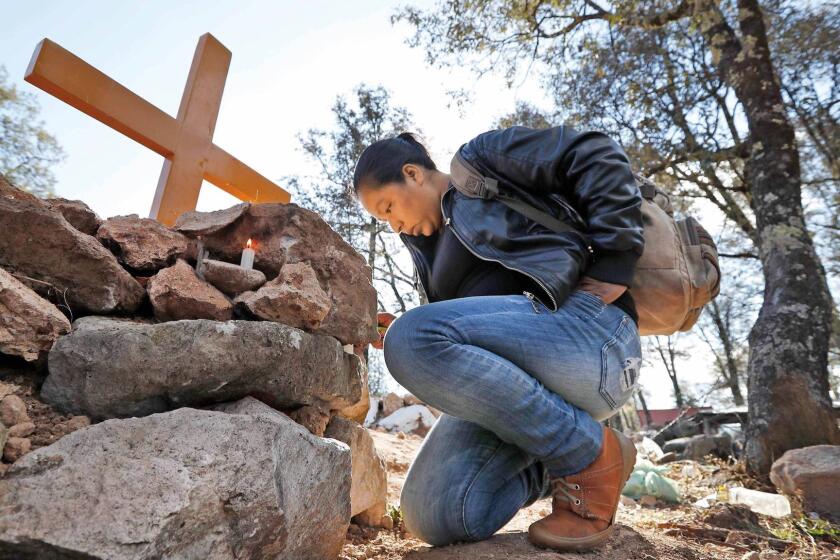 A friend of Isidro Baldenegro Lopez visits his grave site in January. Baldenegro was the fifth environmental defender killed in the last year in the community of Coloradas de la Virgen, Chihuahua, in the Golden Triangle.