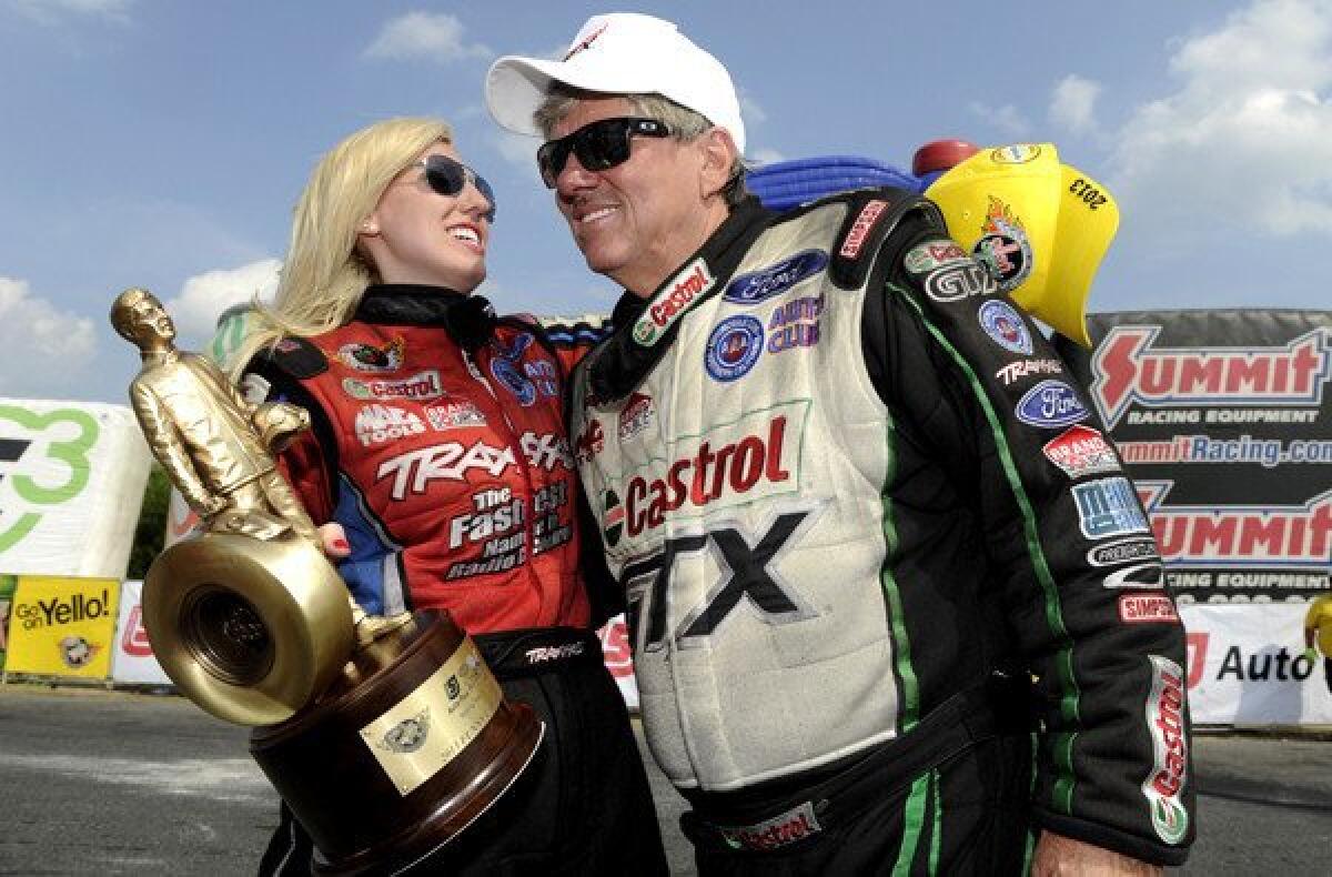 Courtney Force celebrates with her father, John Force, after winning the funny car championship round at the inaugural Auto-Plus NHRA New England Nationals last month.