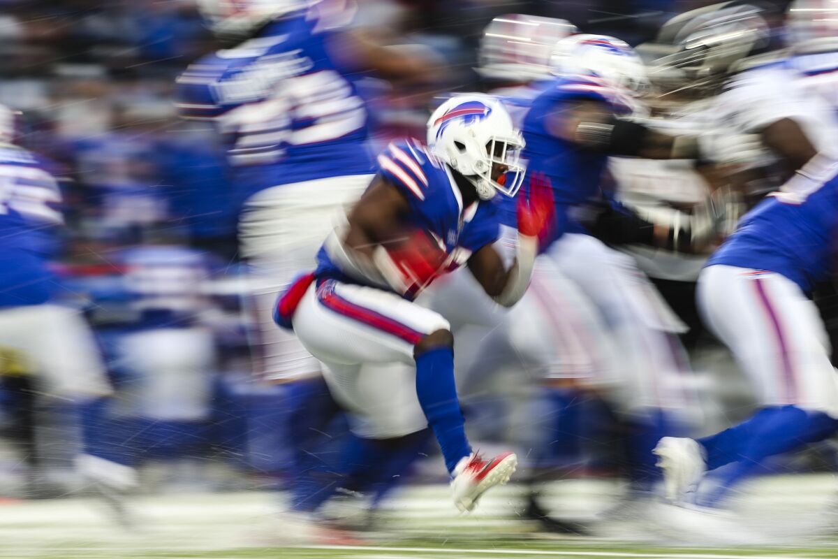 Buffalo Bills running back Devin Singletary (26) rushes during the second half of an NFL football game against the Atlanta Falcons Sunday, Jan. 2, 2022, in Orchard Park, N.Y. The Bills won 29-15. (AP Photo/Joshua Bessex)