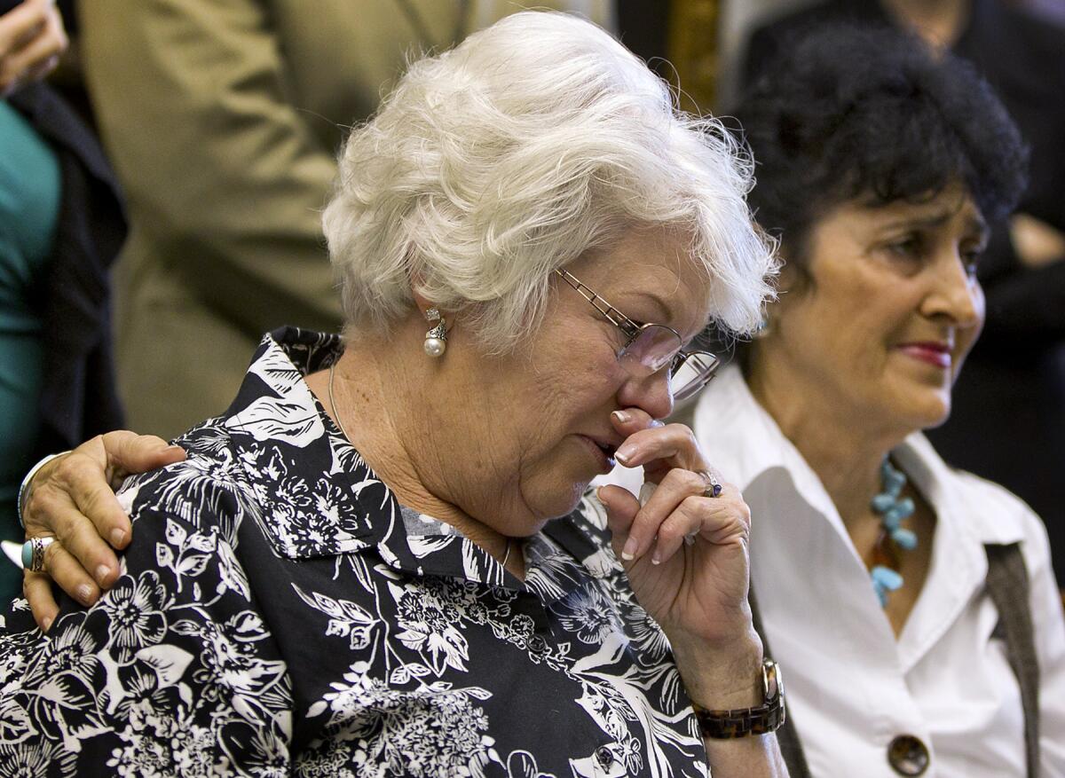 Eugenia Willingham, 70, left, stepmother of Cameron Todd Willingham, is comforted after speaking about her stepson, who was convicted and executed for an arson murder, during a news conference in 2012. The family is seeking a posthumous pardon for Willingham.