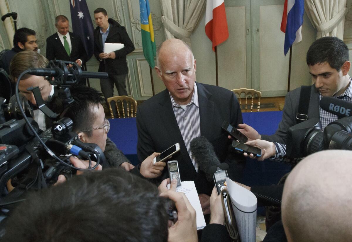 Gov. Jerry Brown speaks to the media after a signing ceremony at the COP 21, the U.N. climate change conference in Paris.