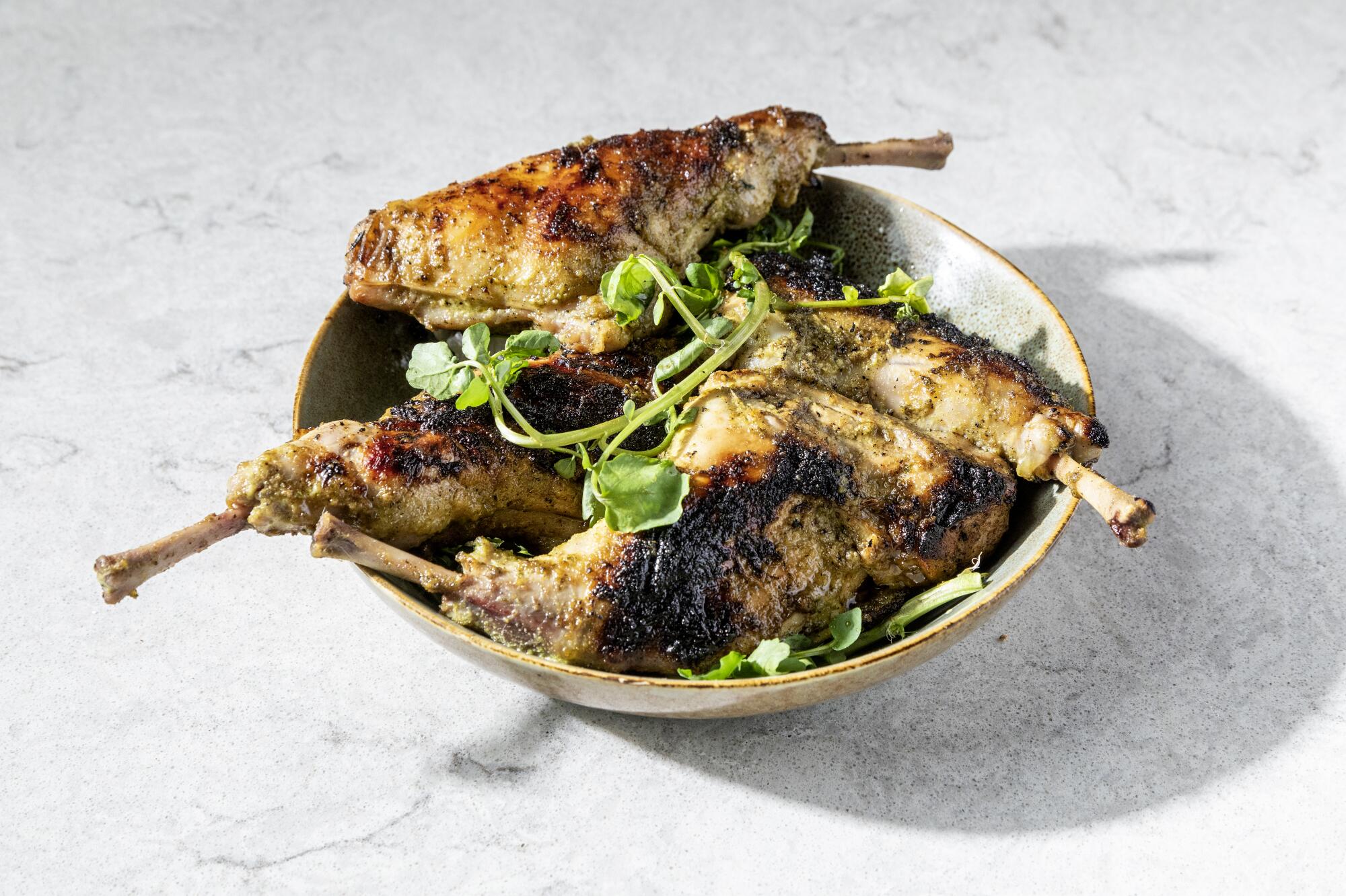 Grilled rabbit legs brined with coriander, fennel and thyme.