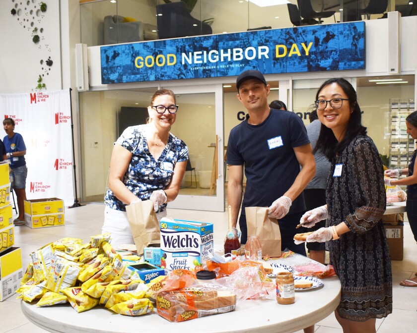 Cheena Malicki, Andrei Hluski and Nancy Zhang making sack lunches for Interfaith Community Services in Escondido.