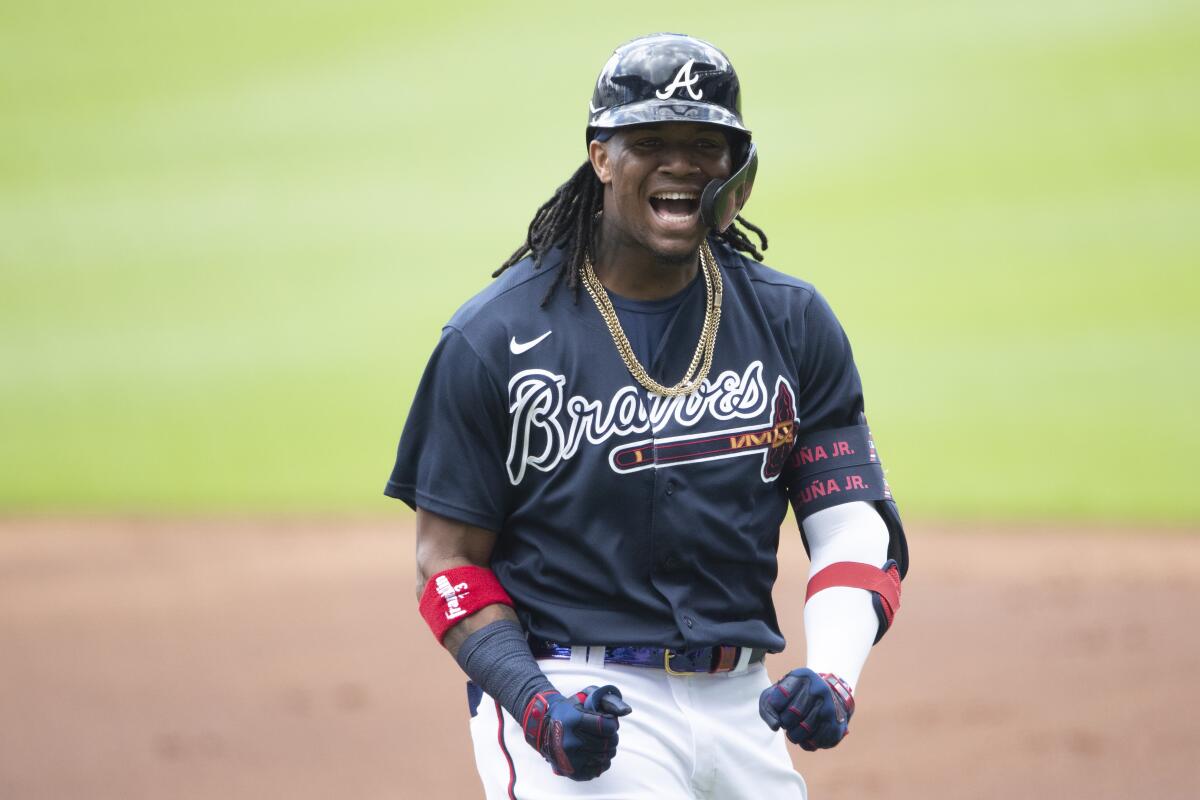 Ozzie Albies pushes Jean Segura hand off base