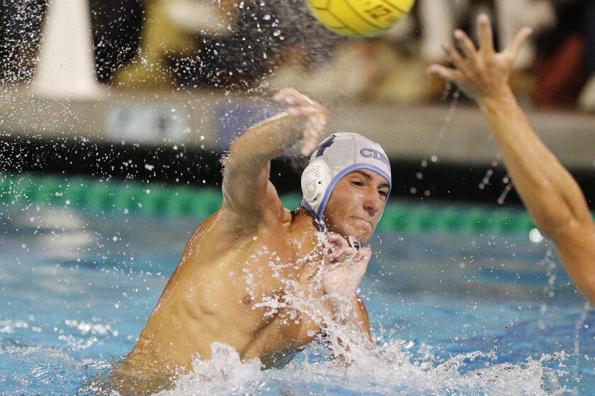 Corona del Mar High's Tyler Harvey shoots and scores in a Surf League boys' water polo match at Newport Harbor High on Wednesday, October 3, 2018.