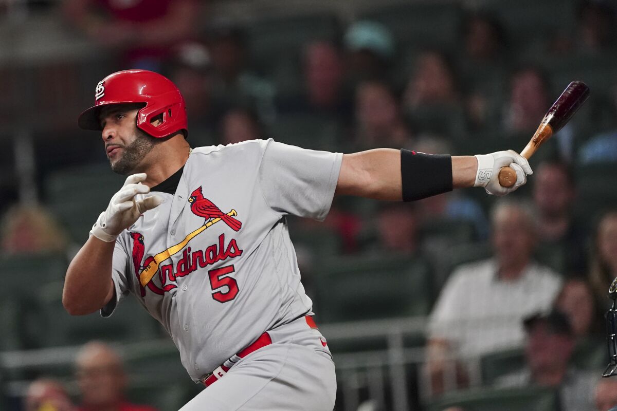 St. Louis Cardinals pinch hitter Albert Pujols drives in a run with a sacrifice fly in the seventh inning of a baseball game against the Atlanta Braves, Thursday, July 7, 2022, in Atlanta. (AP Photo/John Bazemore)