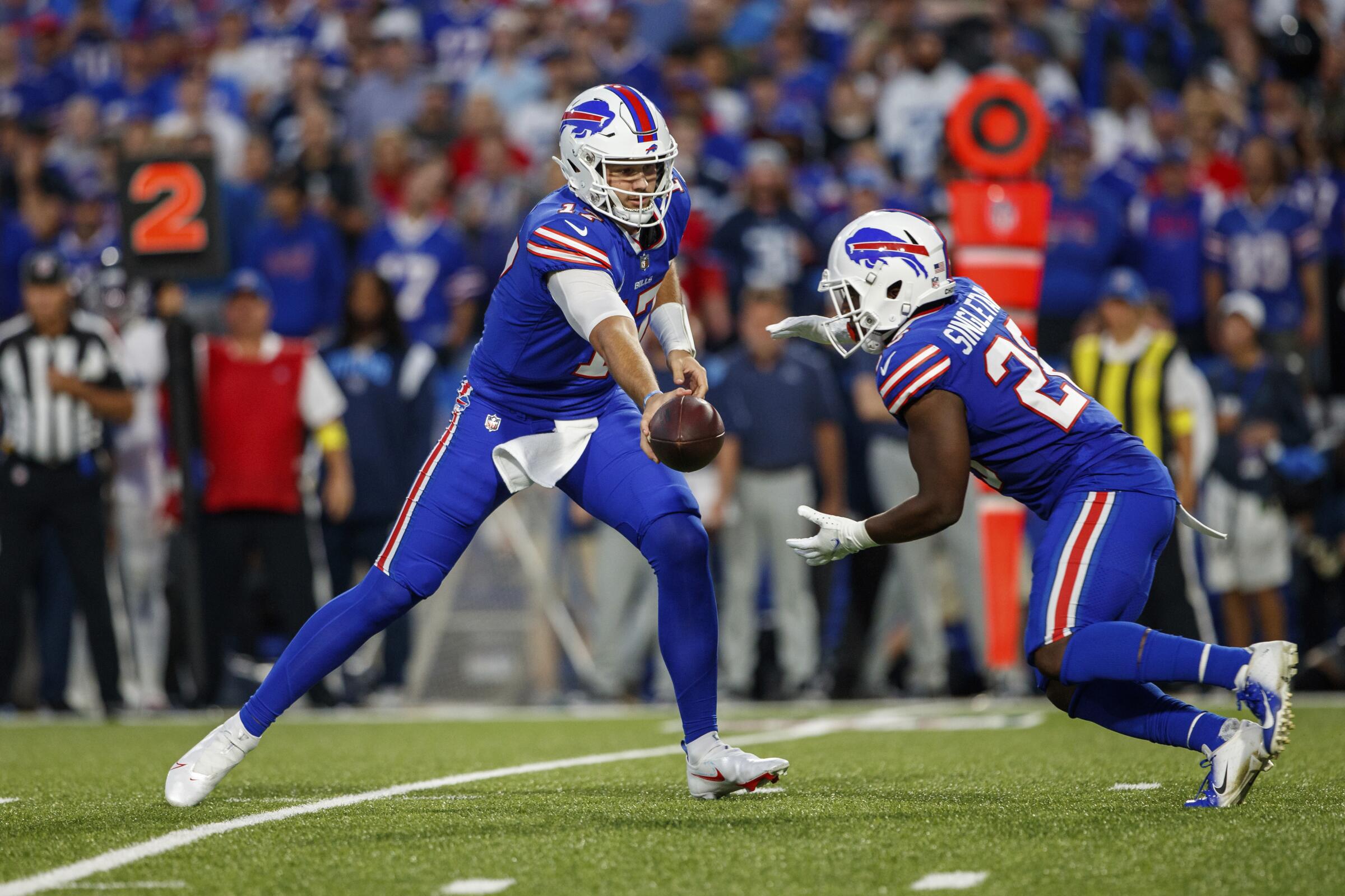 Buffalo Bills quarterback Josh Allen hands the ball off to running back Devin Singletary.