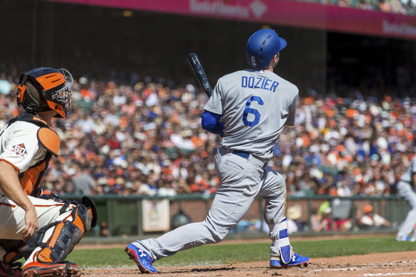 Los Angeles Dodgers Brian Dozier hits a two-run homer against the San Francisco Giants in the third inning of a baseball game in San Francisco, Sunday, Sept. 30, 2018.