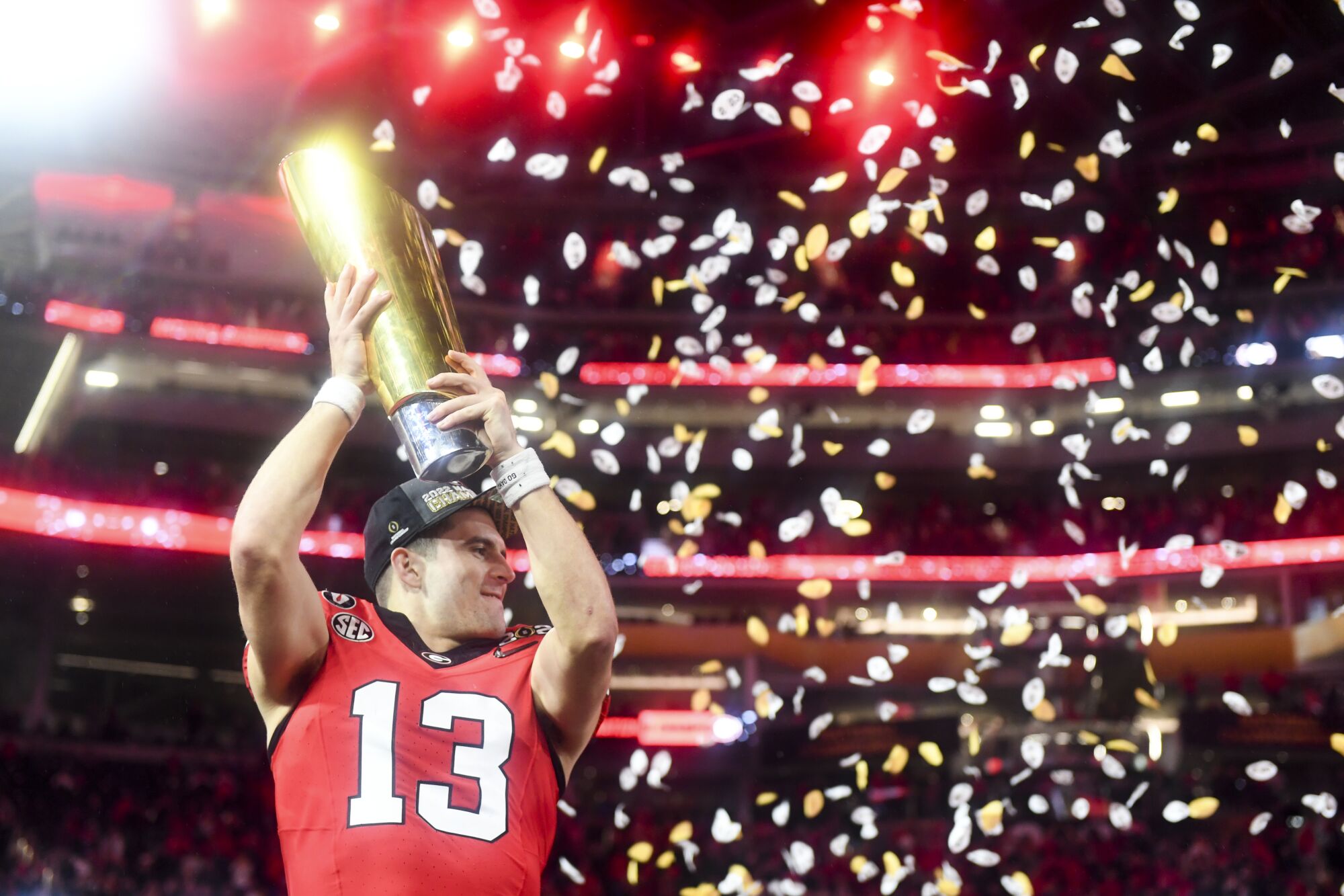 Georgia quarterback Stetson Bennett celebrates with the national championship trophy.