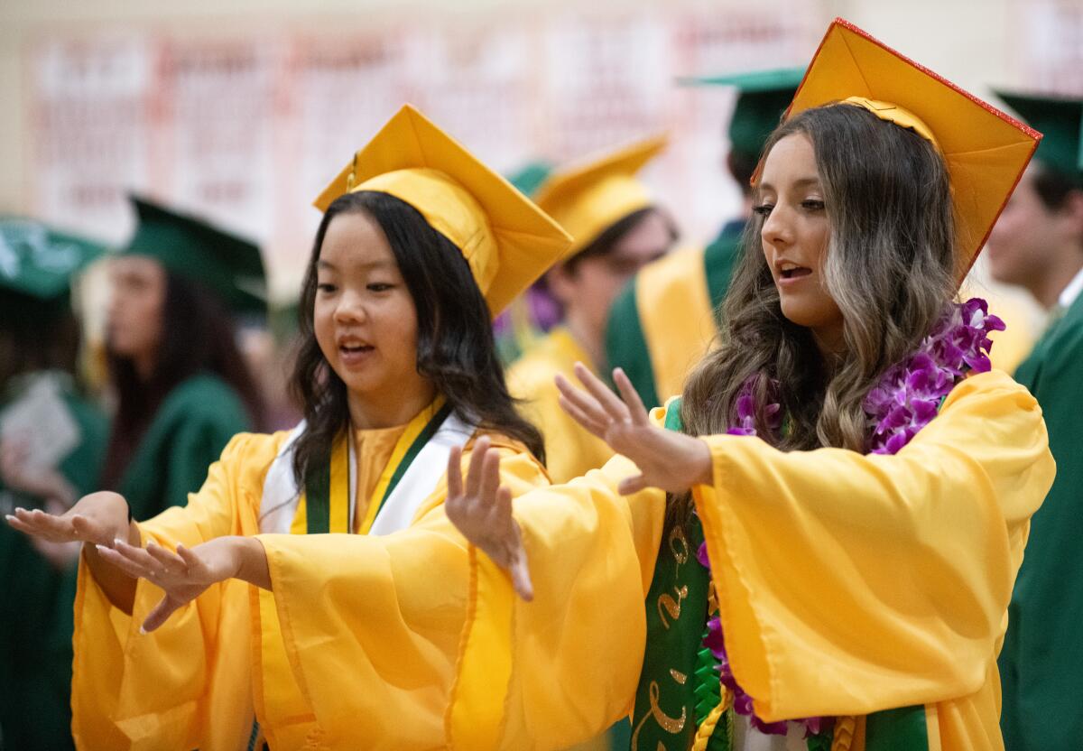 Olivia Lee and Eva Emerson practice performing the national anthem in sign language ahead of Edison High School's graduation.