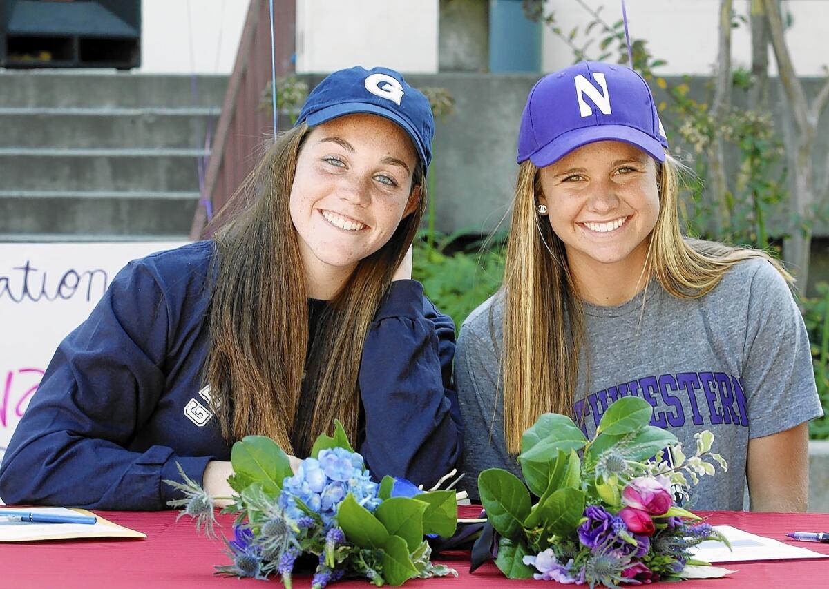 Lauren O'Leary and Anna Edwards smile for the photographers after they signed early letters of intent to for full-ride scholarships they earned for their prowess in softball on Tuesday, November 17, 2010. O'Leary will attend Georgetown in the Fall, and Edwards will attend Northwestern.