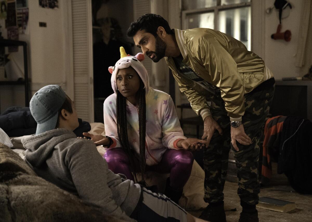 Issa Rae, center, and Kumail Nanjiani, right, in "The Lovebirds."