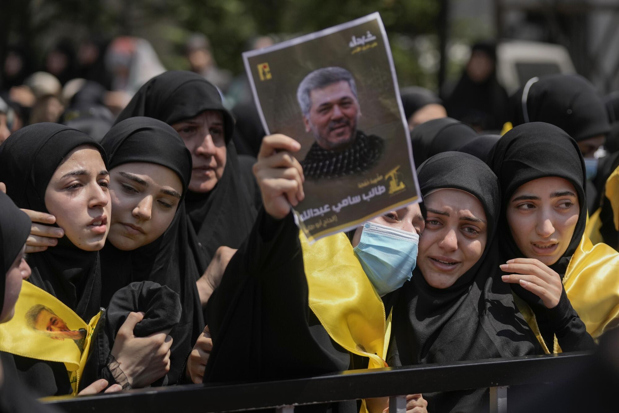 Relatives of Hezbollah senior commander Sami Taleb Abdullah mourn during his funeral in Beirut.