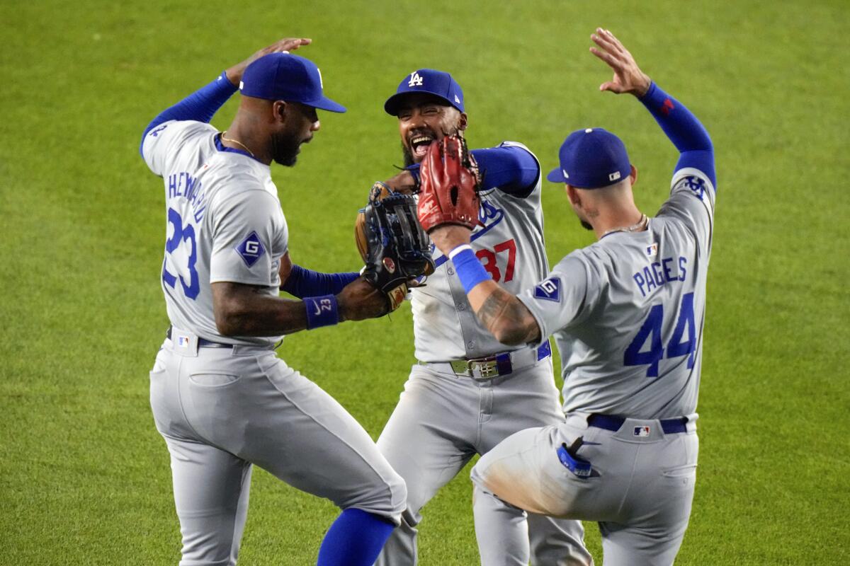 Dodgers teammates Jason Heyward, Teoscar Hernández and Andy Pages celebrate.